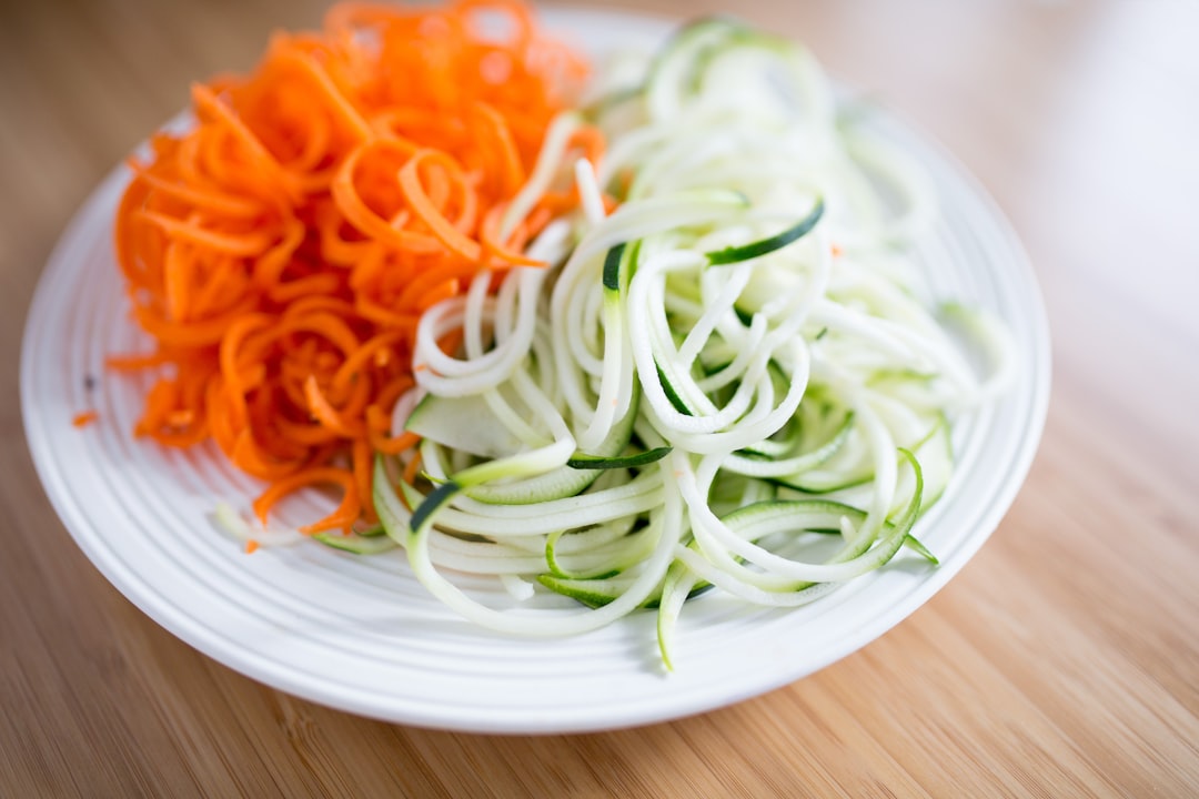 Vegetable chopper and spiralizer with colorful spiralized vegetables