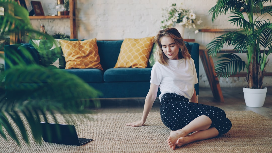 Person stretching and doing yoga poses on mat at home