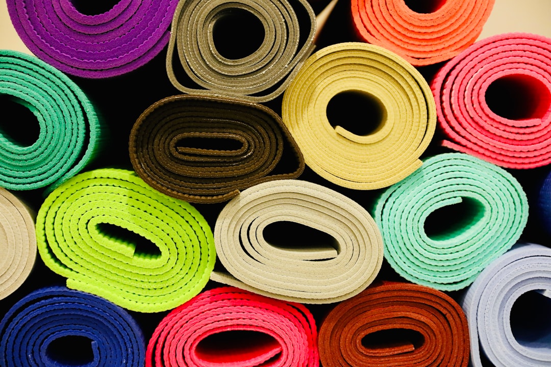Colorful yoga mats rolled up and ready for practice
