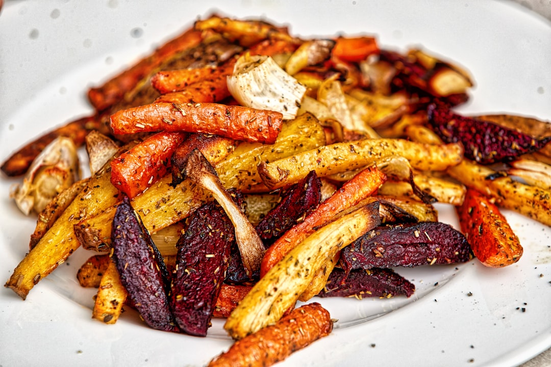 Air fryer with crispy roasted vegetables and modern kitchen setup