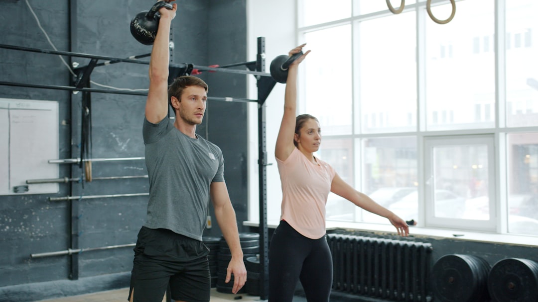 Man performing goblet squat with kettlebell