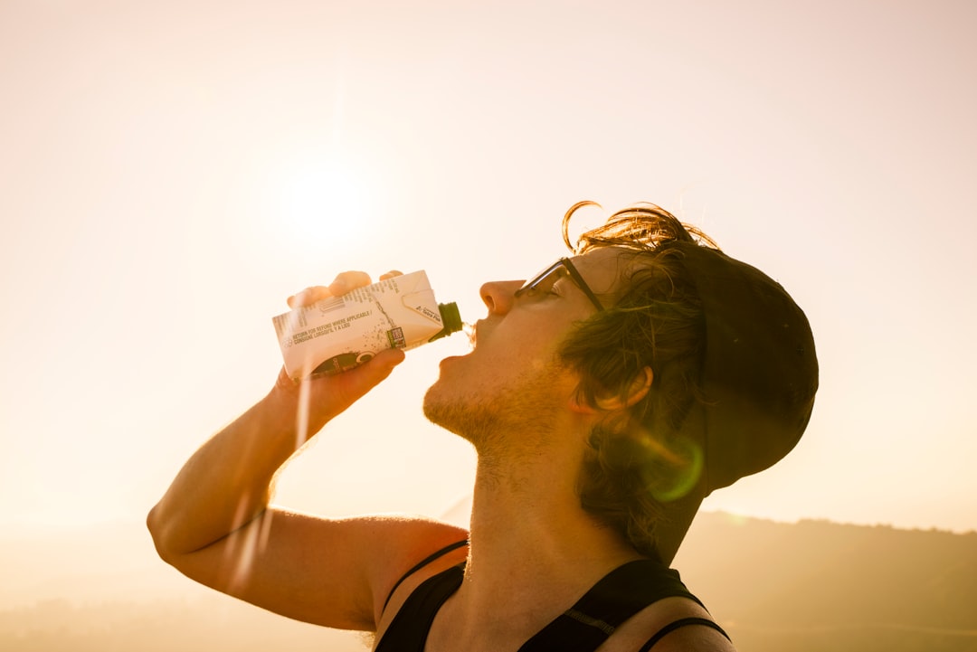 Athlete drinking water from bottle during outdoor workout