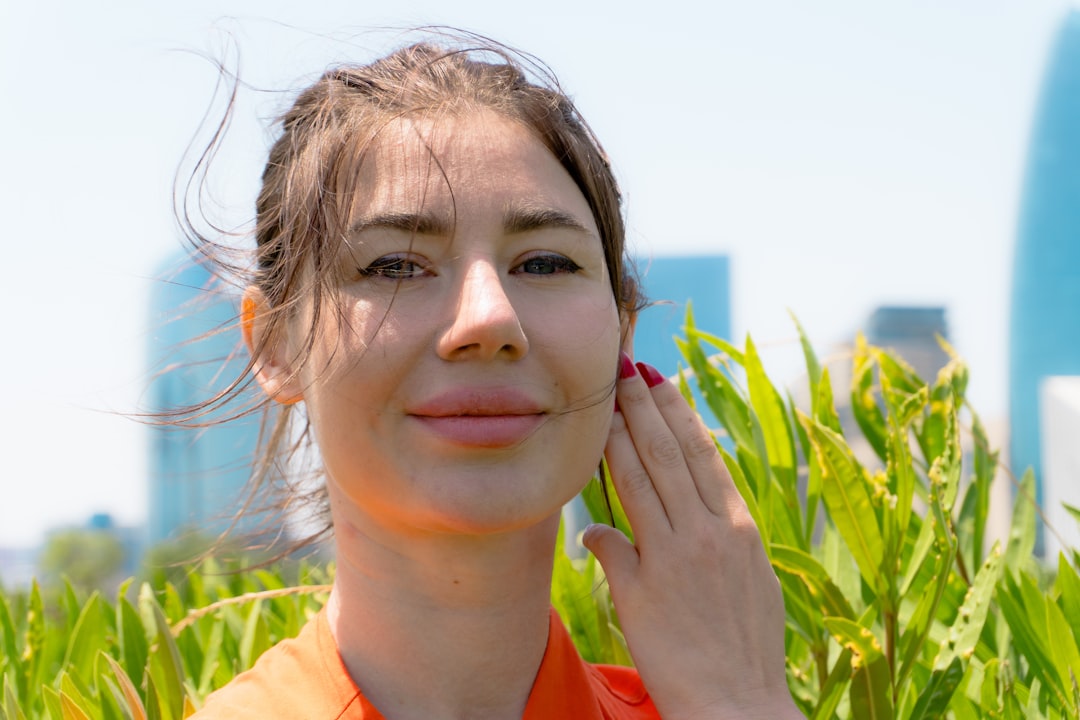 Woman applying sunscreen before outdoor workout