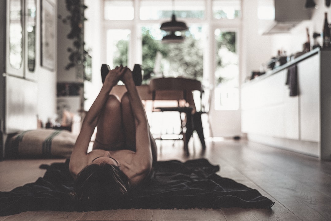 Woman practicing yoga on home gym floor