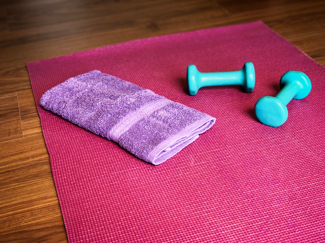 Woman stretching with yoga mat in home fitness space