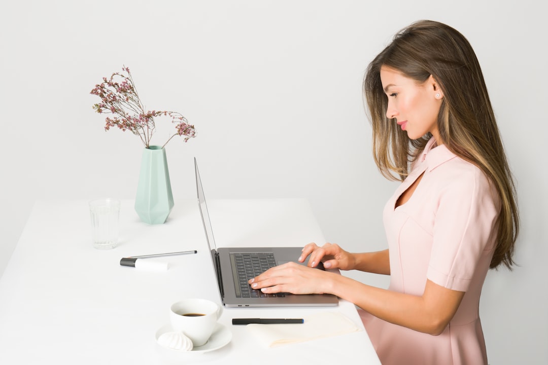 Woman concentrating while working at a desk with notebooks