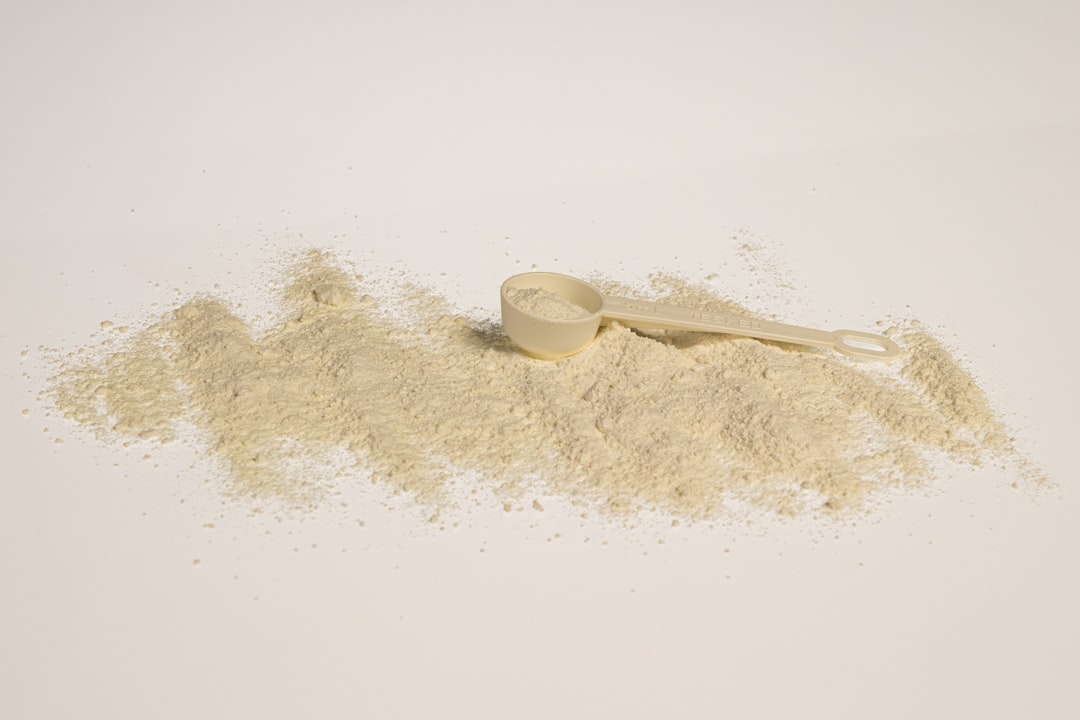Organic functional mushroom powder measured in a wooden spoon