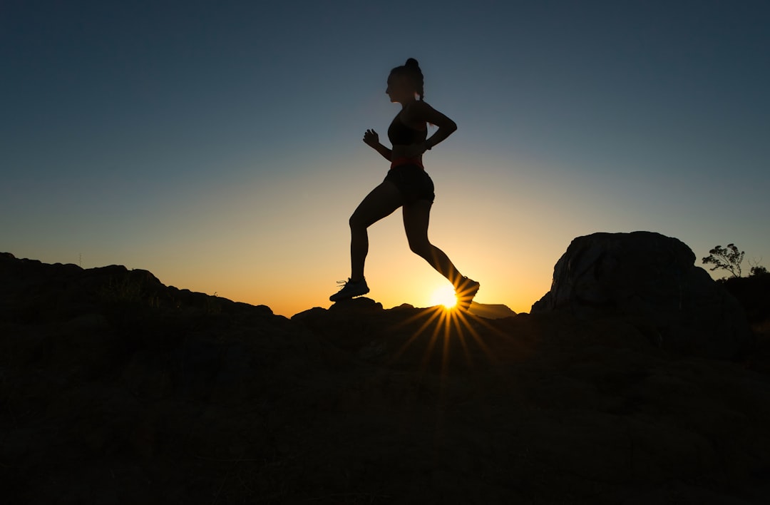 Women running outdoors on a sunny morning trail