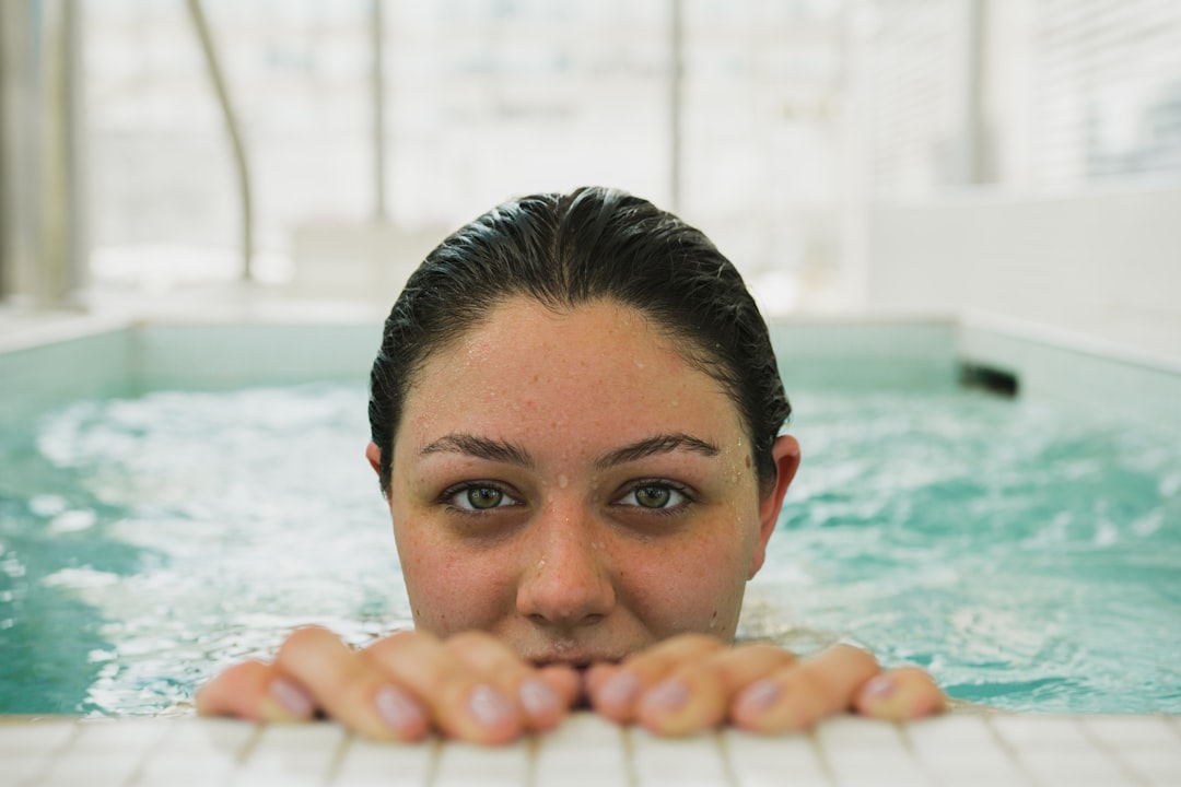 Person in cold plunge ice bath for athletic recovery and inflammation reduction