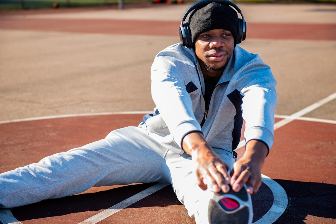 Athlete performing recovery stretching routine after intense workout session