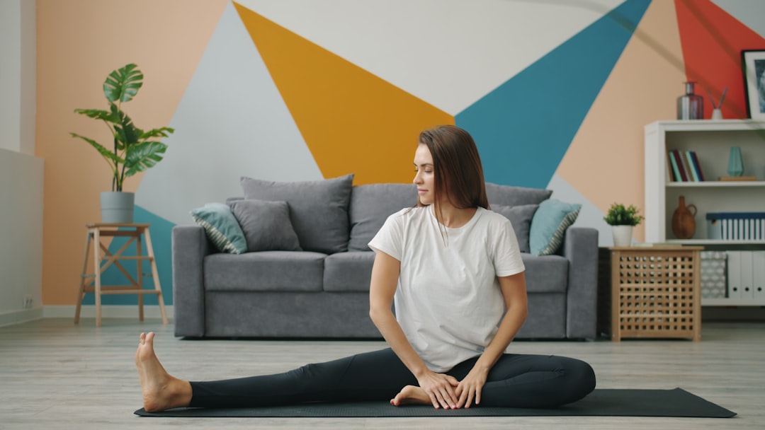 Happy woman exercising with cable machine at home
