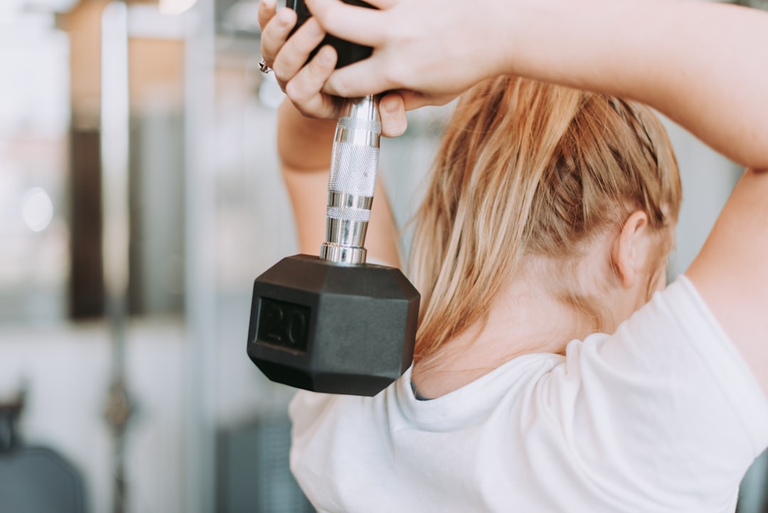 Woman performing cable exercises in home gym setup