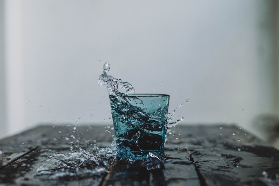 Pouring cold refreshing water into a glass
