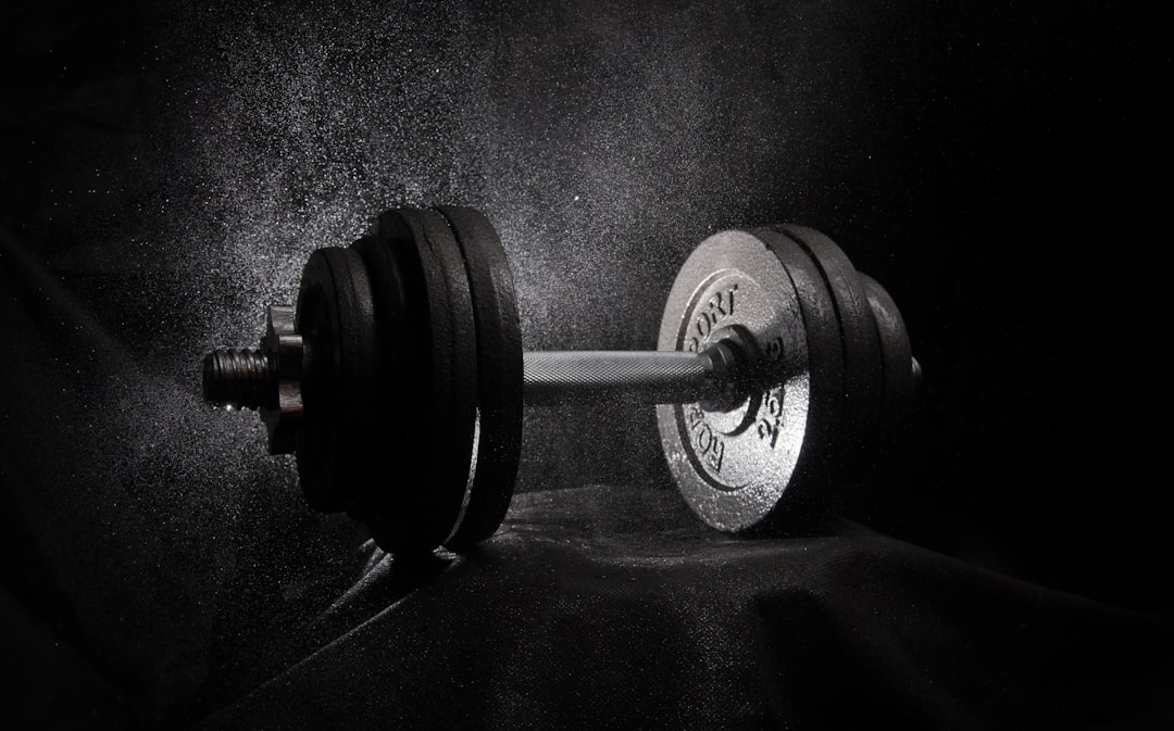Barbell with weight plates in a gym setting