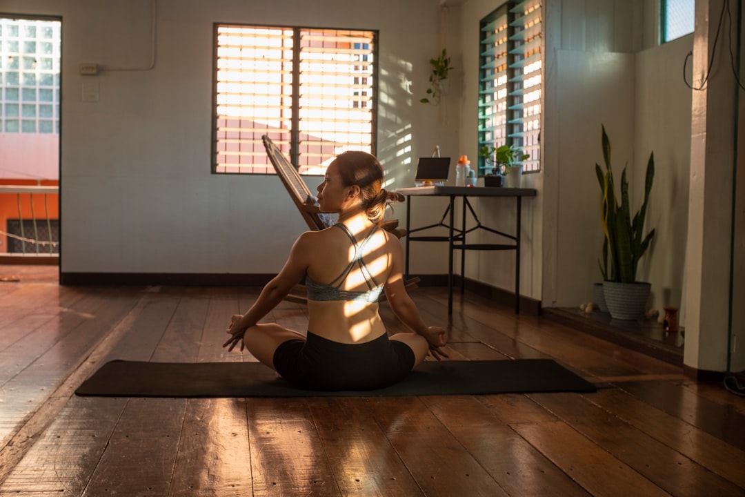 Woman exercising at home on yoga mat