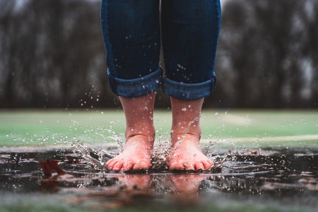 Person stepping into cold water for therapy