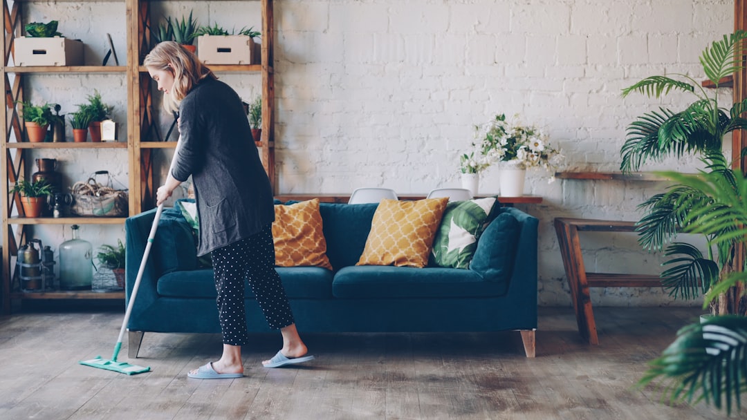 Compact walking pad tucked under a couch in a small apartment