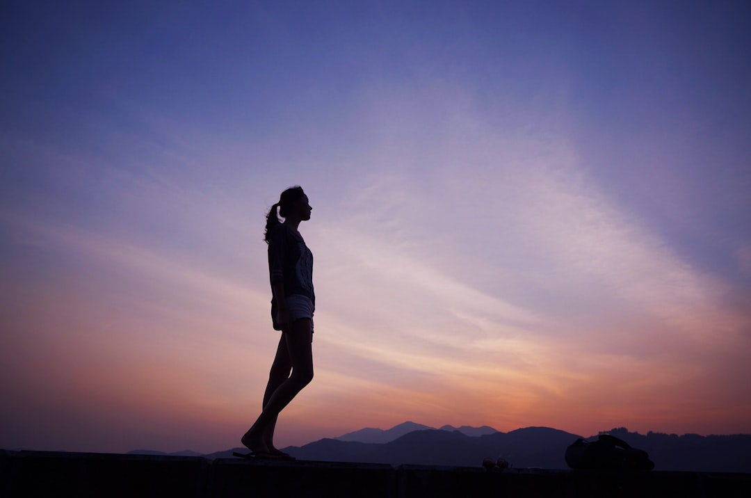 Runner on a trail at dawn with soft golden light