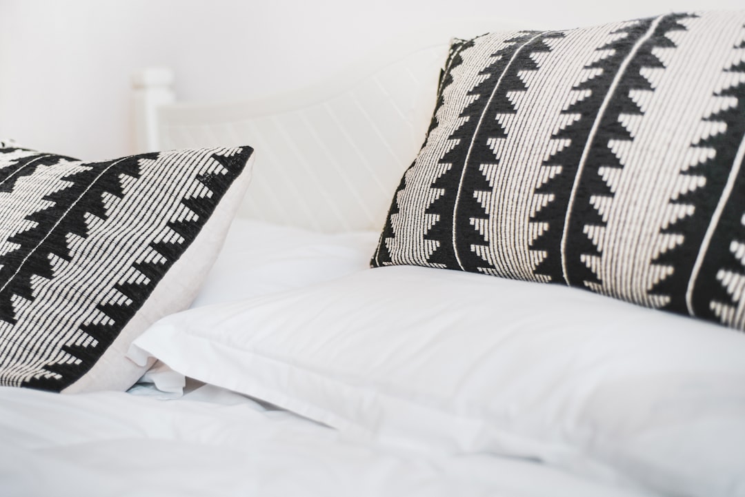 Comfortable white bed with quality pillows for restful sleep