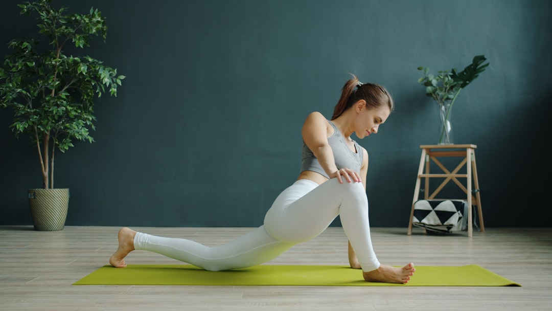 Person doing yoga stretching on mat at home
