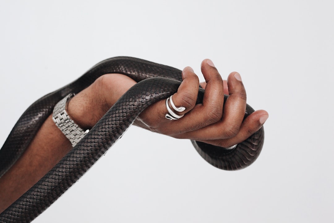 Minimalist black smart ring resting on surface