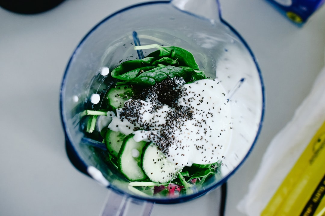 Green smoothie in blender on kitchen counter