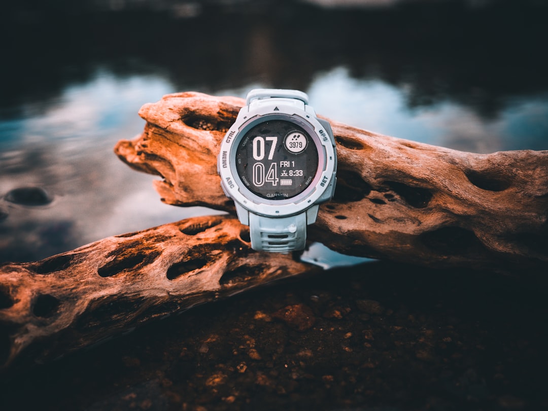GPS running watch on a runner's wrist showing pace and distance data
