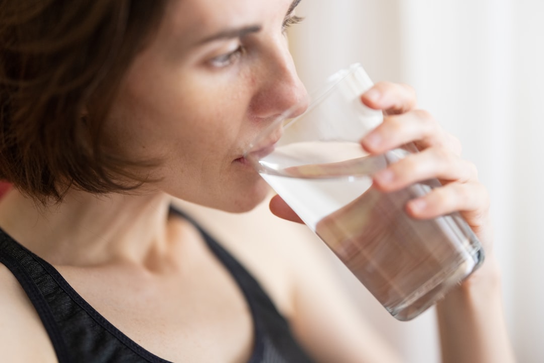 Woman drinking water with morning wellness routine