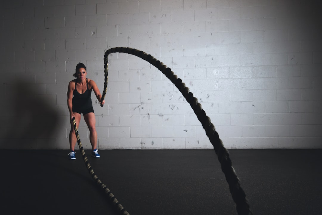 Woman training with determination at the gym, demonstrating strength and focus