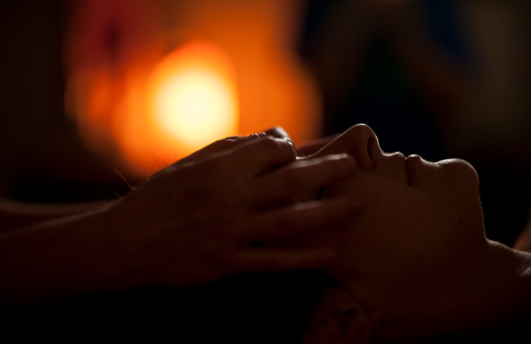 Fitness woman receiving facial jaw massage therapy