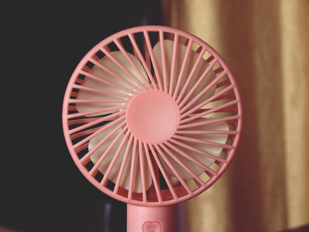 Portable misting fan providing cooling relief during outdoor summer activity