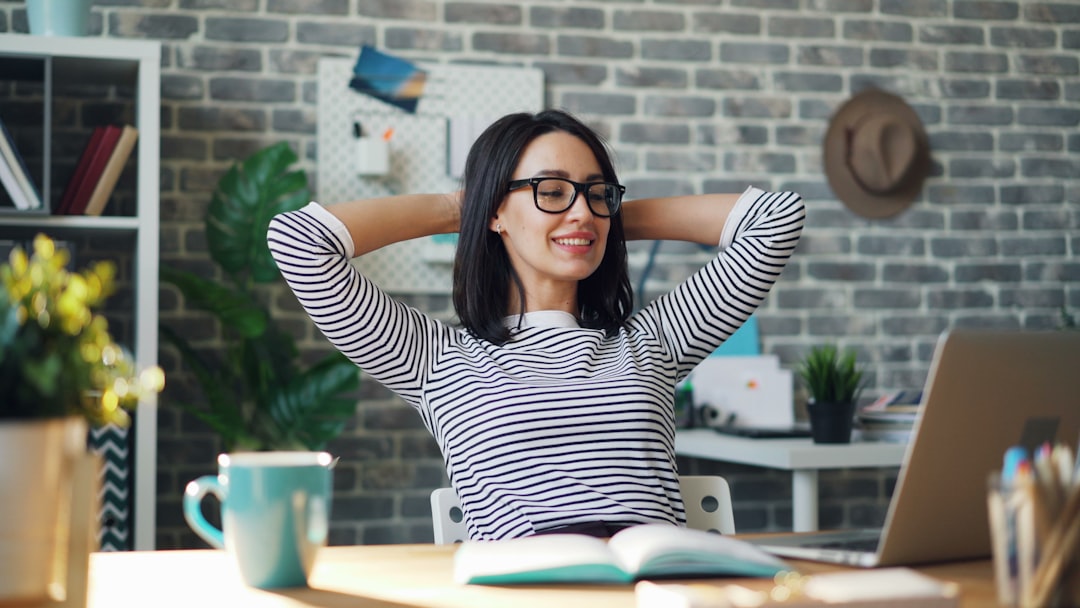 Woman doing shoulder mobility exercises at a desk