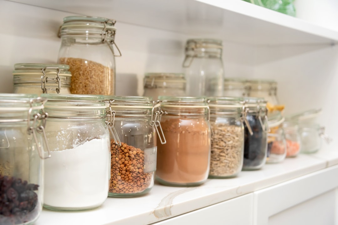 Protein powder jars organized on a pantry shelf