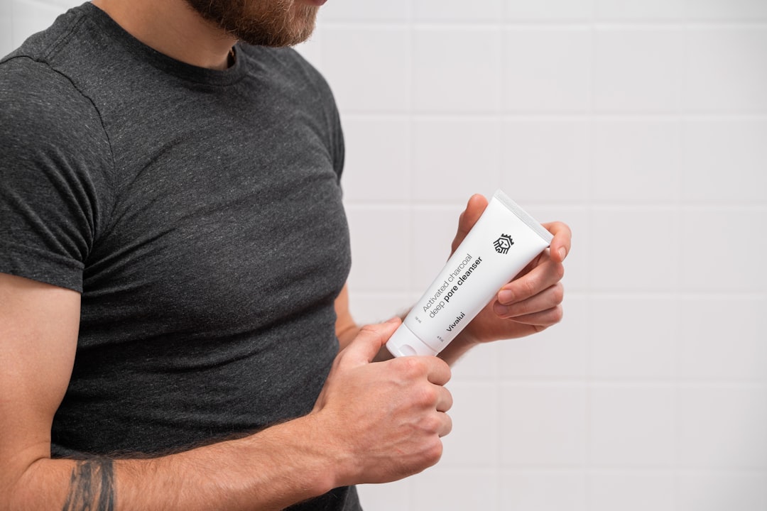 Applying muscle recovery cream to sore muscles