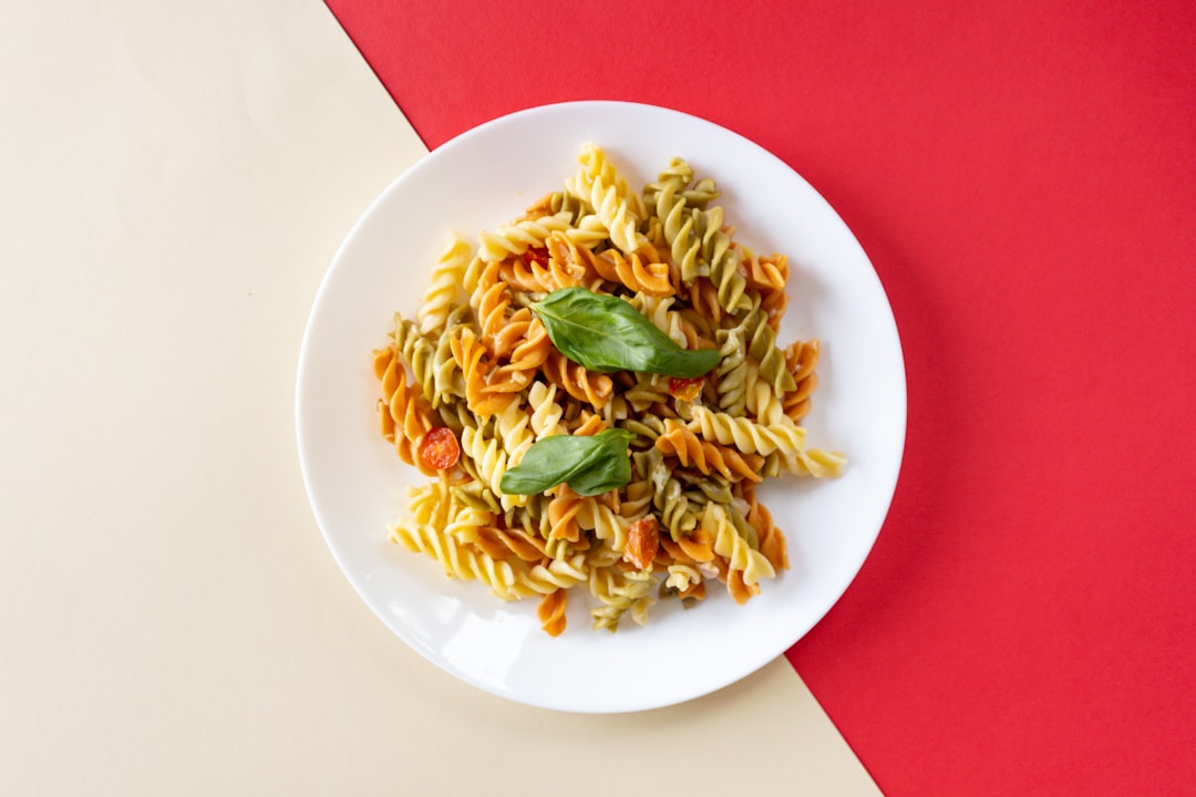 Lentil pasta dish with vegetables on dinner plate