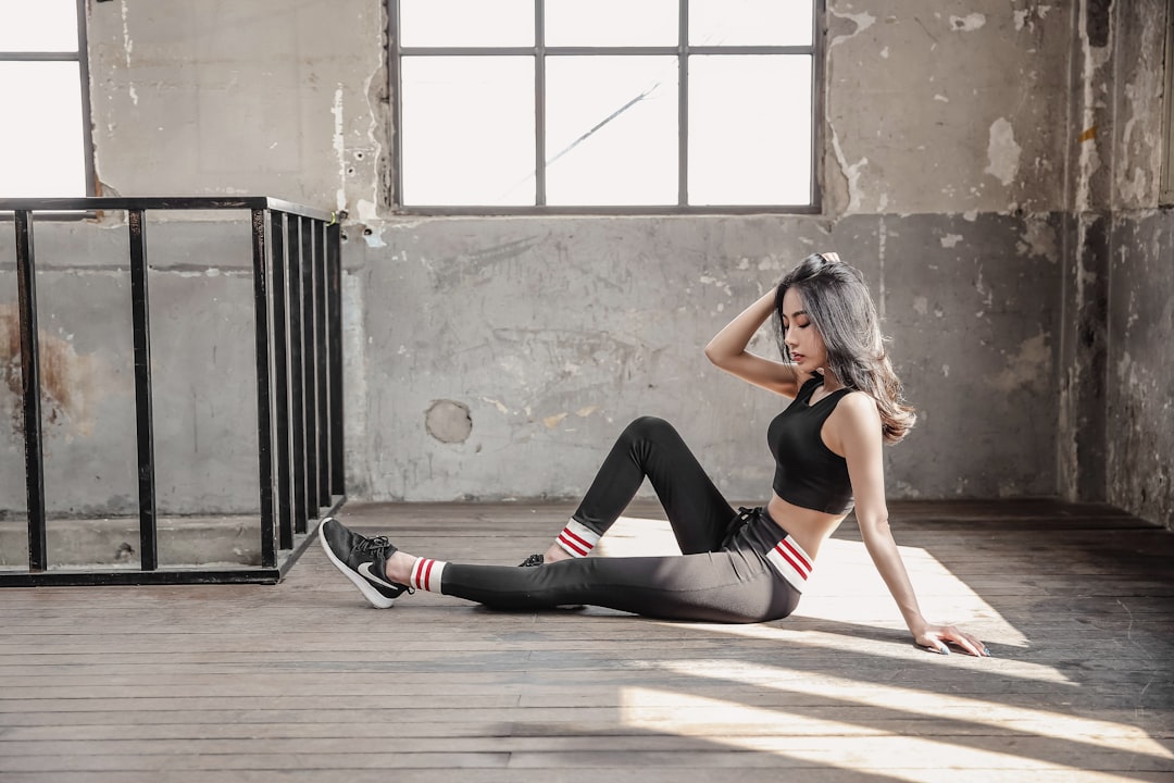 Woman performing leg exercises wearing ankle weights