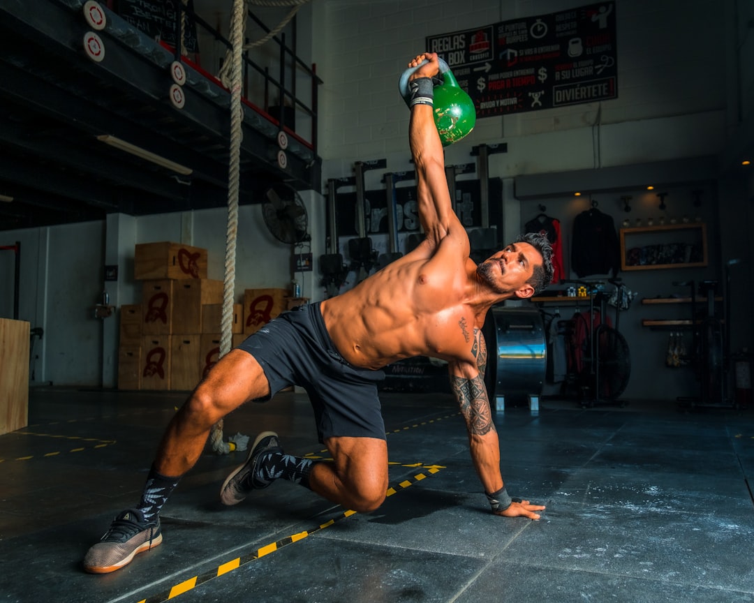 Athlete training with a cast iron kettlebell in a gym