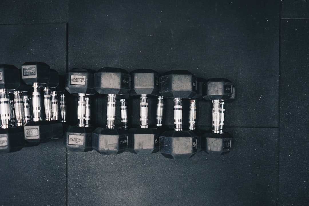 Adjustable dumbbells with weight plates on the floor
