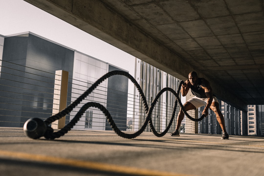 Athlete training with battle ropes during a high-intensity interval workout