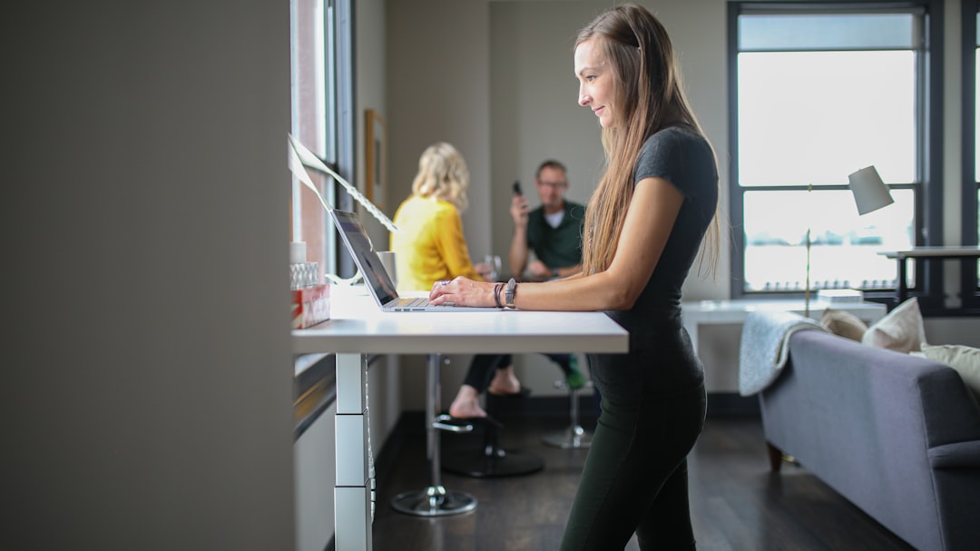 Woman working at a standing desk in an office