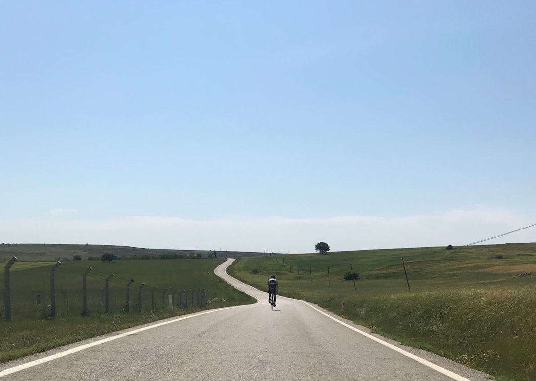 Cyclist riding alone along a quiet country road
