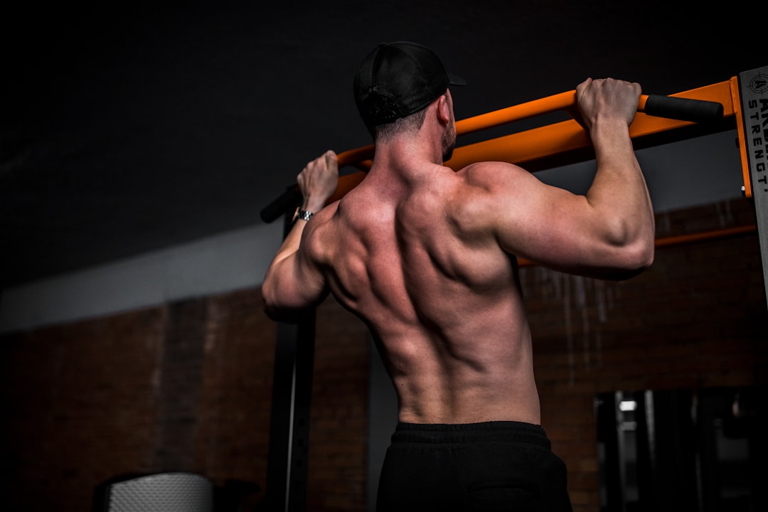 Man performing a pull-up on a bar