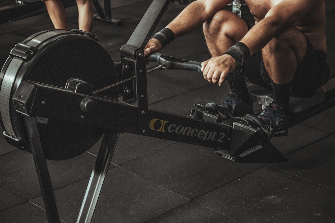 Athlete working hard on a rowing machine during an interval session