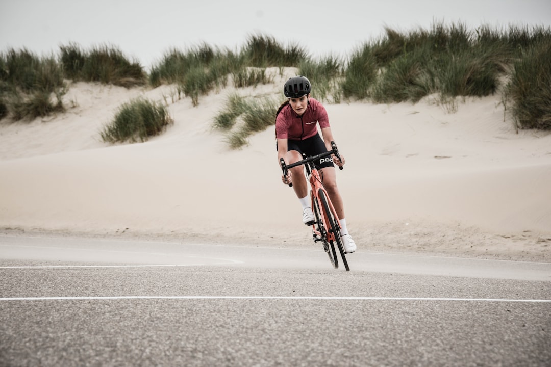 Cyclist riding outdoors while tracking performance data