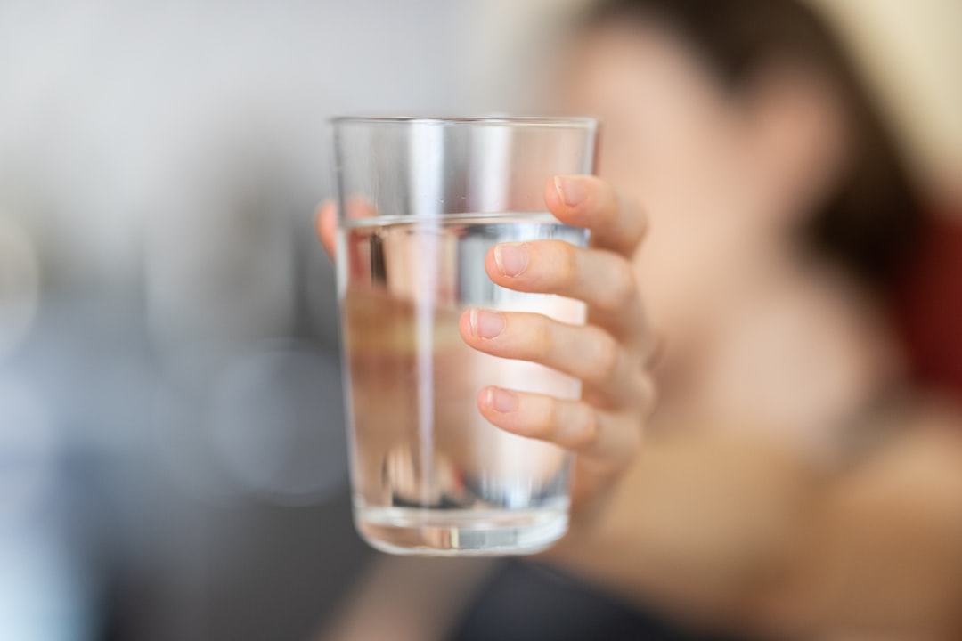 Glass of water on a nightstand for morning hydration