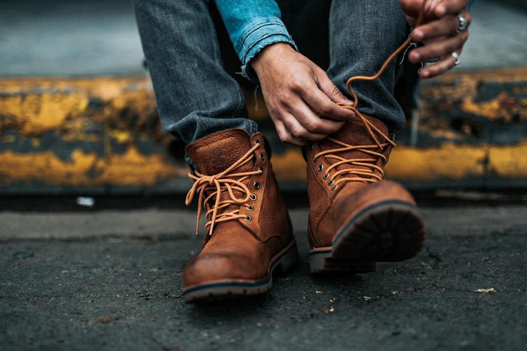Close-up of hands lacing walking shoes