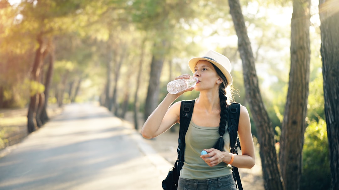Hiker drinking water on a sunny trail