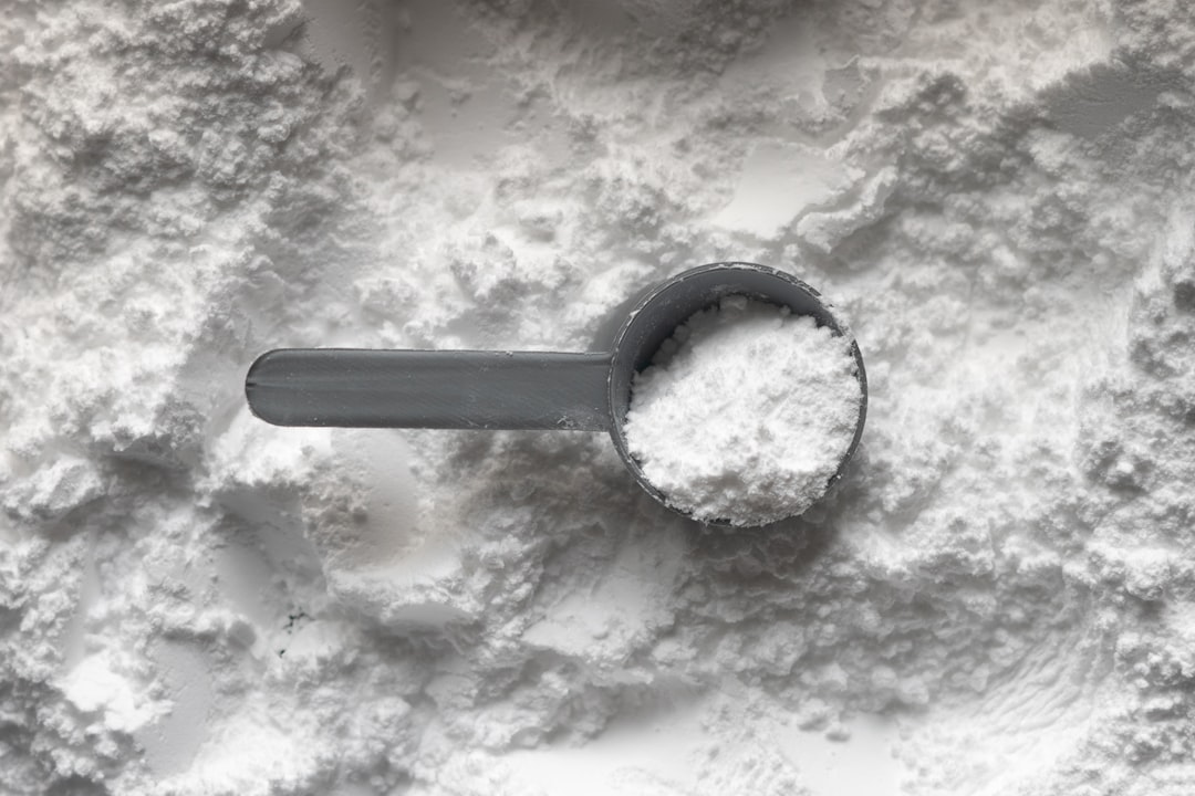 Measuring supplement powder with scoop and scale