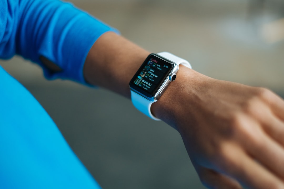 Runner checking a sports watch on the wrist mid-run