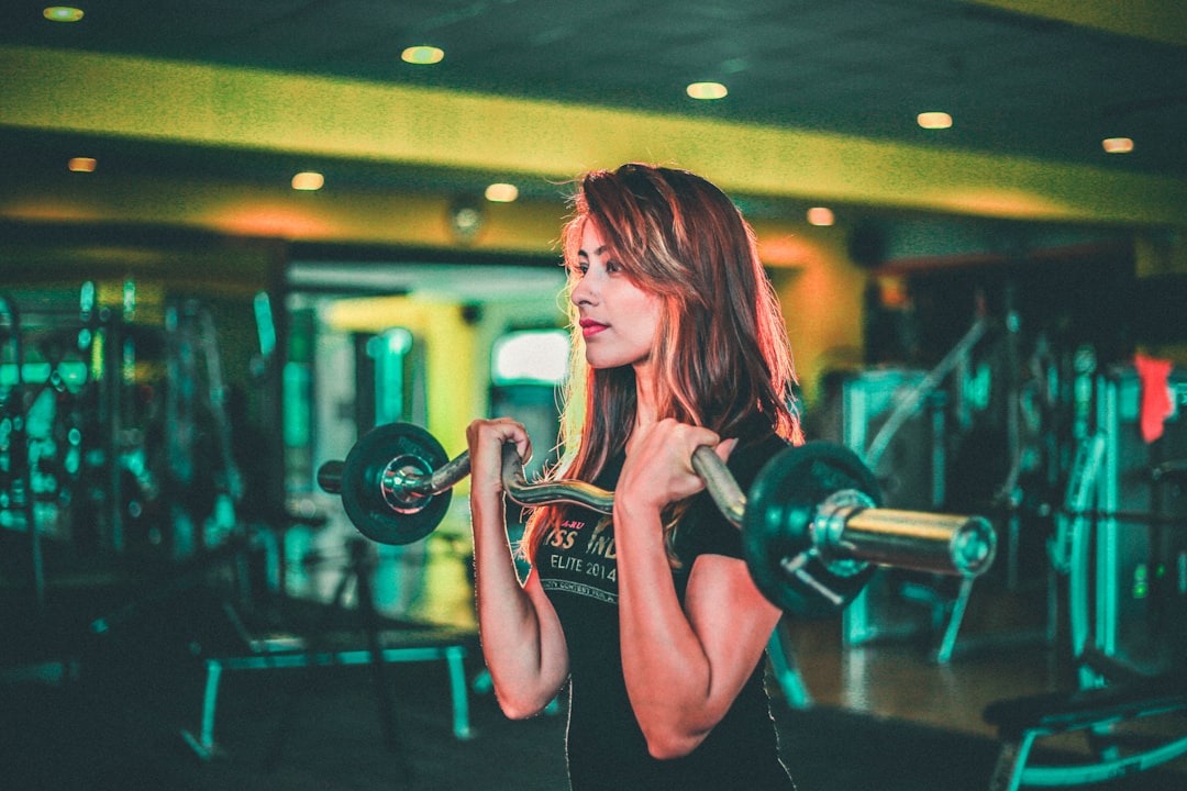 Woman strength training with cable equipment